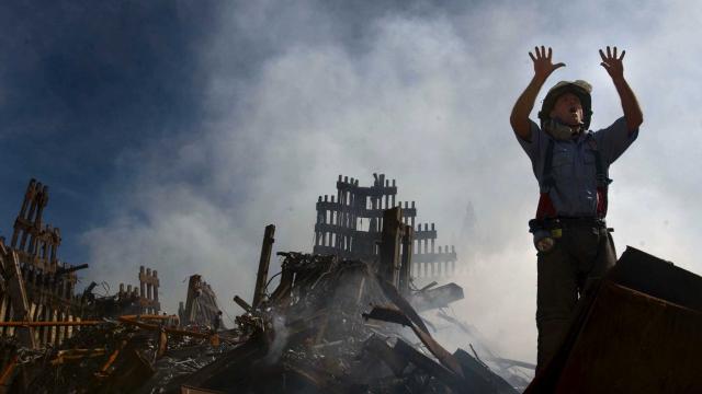 A New York City fireman calls for more rescue workers to make their way into the rubble of the World Trade Center September 14, 2001 days after the September 11, 2001 terrorist attack.JIM WATSON/GETTY IMAGES / U.S. NAVY/GETTY IMAGES