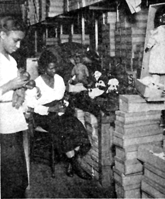 Old days in Harlem: A Negro doll factory in Harlem which provides colored dolls for Negro children