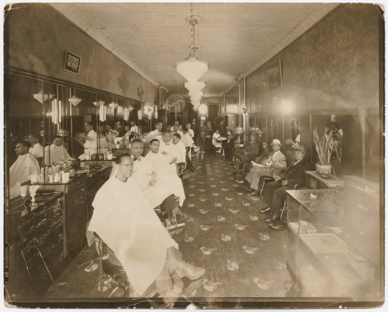 Old days in Harlem: View of Harlem barbershop.